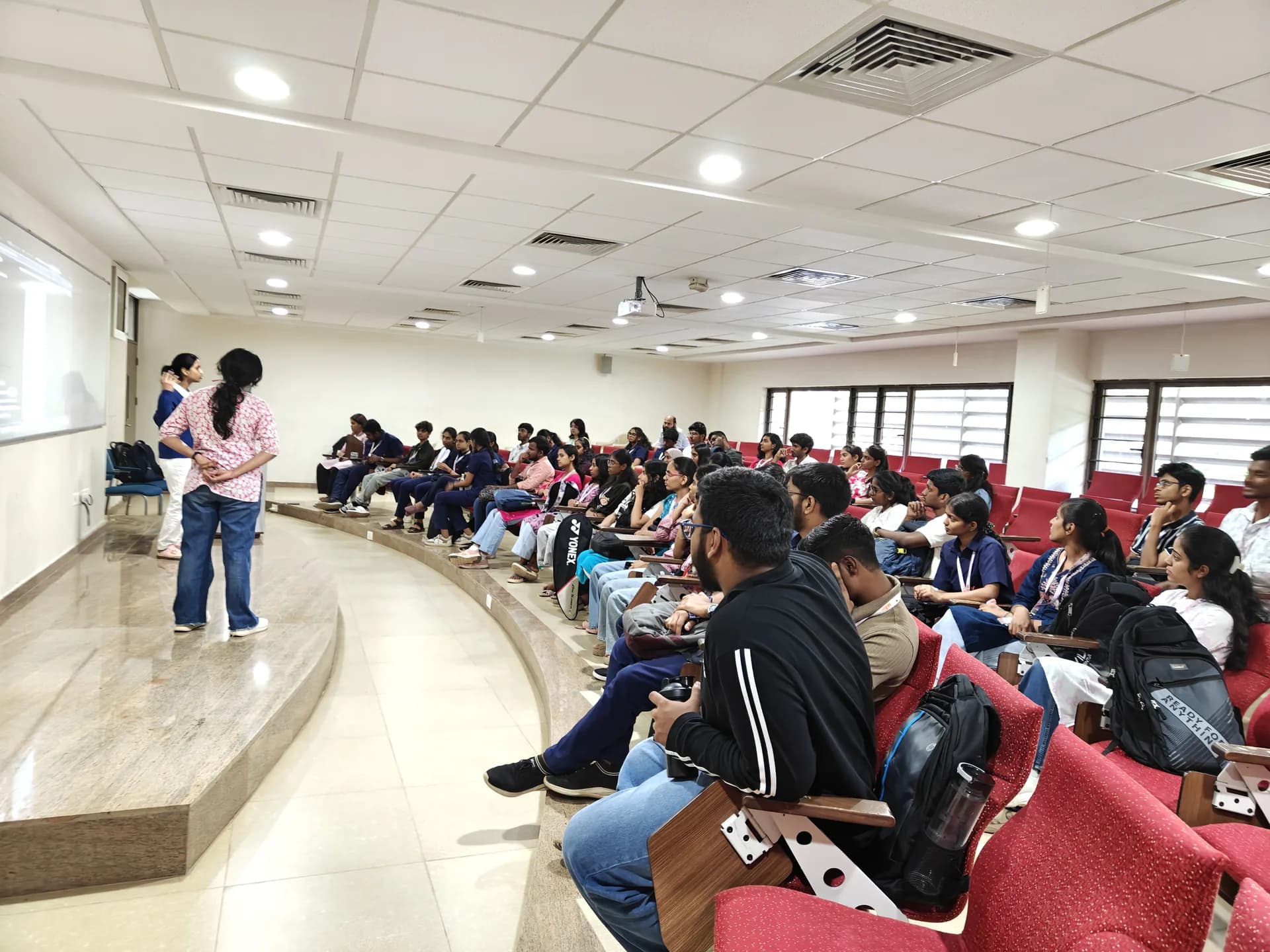 Club members presenting to students in a lecture hall